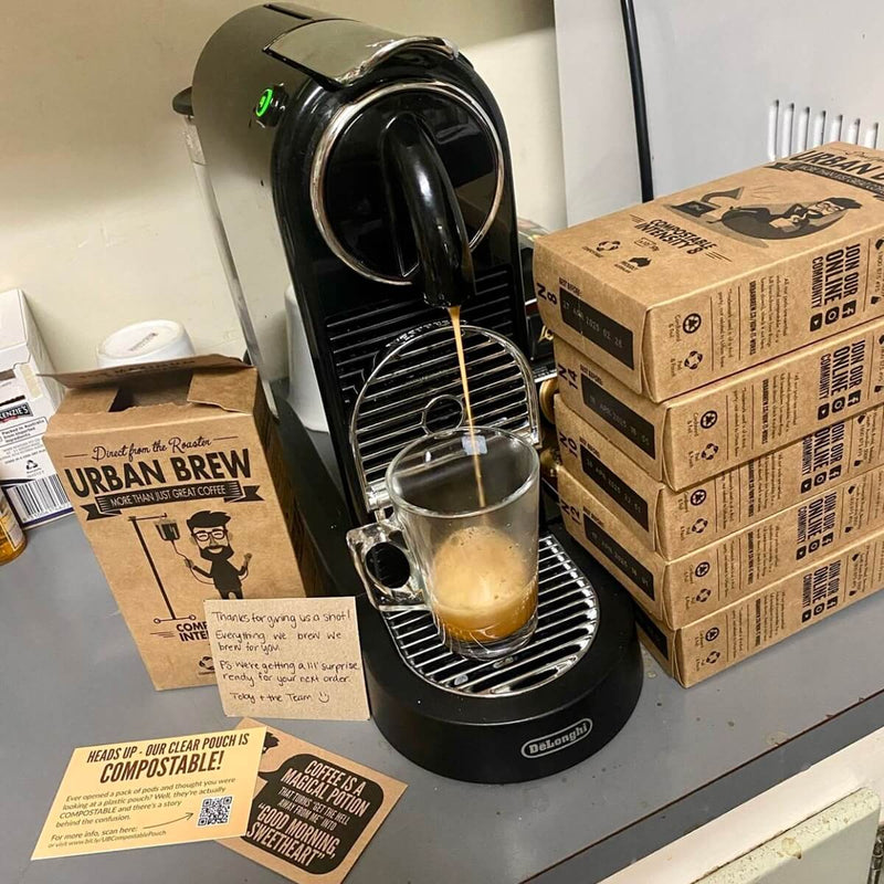 Customer photo: Urban Brew pod brewing in a Nespresso®*-compatible machine, beside stacked pod boxes and a handwritten thank-you note