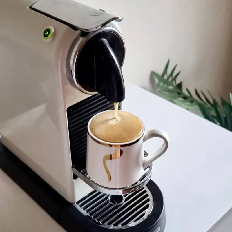 Customer photo: Urban Brew pod brewing in a Nespresso-compatible machine, pouring thick golden crema into a white espresso cup